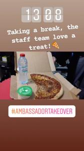 Photo of a takeaway pizza. Text over the image explains that Debbie has stopped for her lunch break and the staff have treated themselves to pizza.