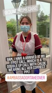 Photo of a care worker wearing a medical face mask, blue gloves and a plastic apron.